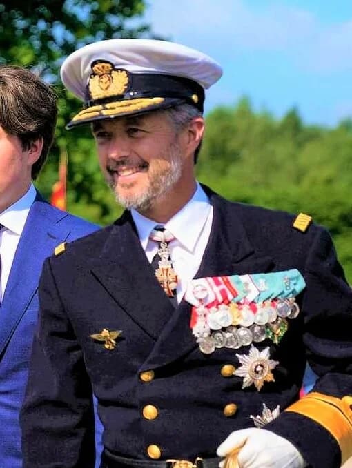 Man in navy dress uniform with medals outdoors