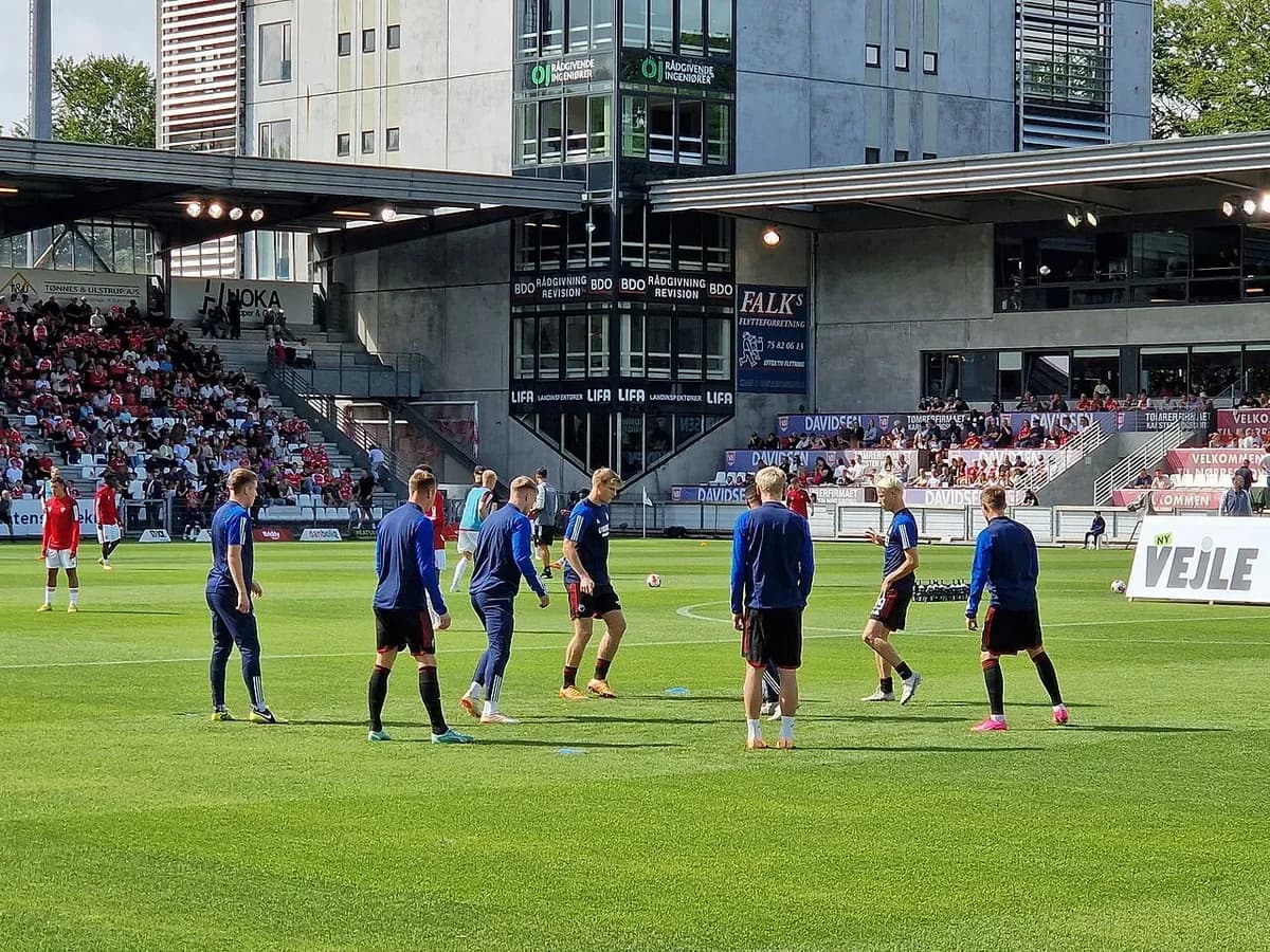 Football players warming up on pitch in stadium