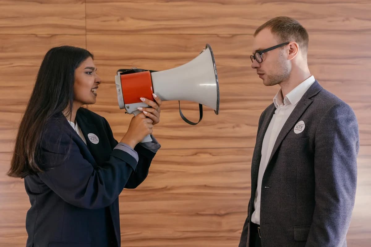 Woman with megaphone facing man in suit