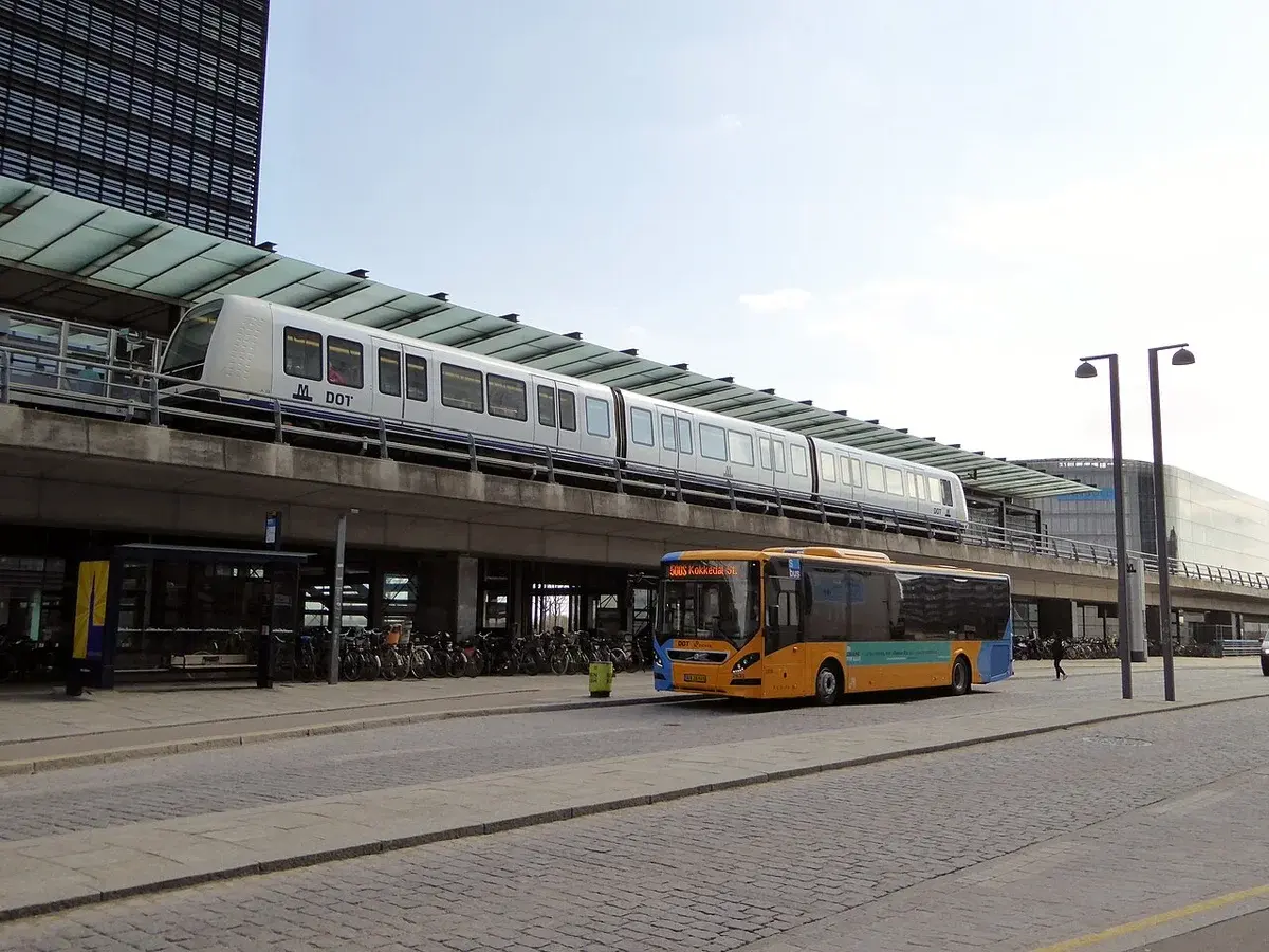 A metro train and a bus at Ørestad Station in Copenhagen.