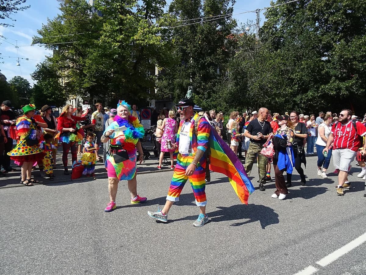 People in colorful rainbow outfits walking and celebrating at Copenhagen Pride Parade