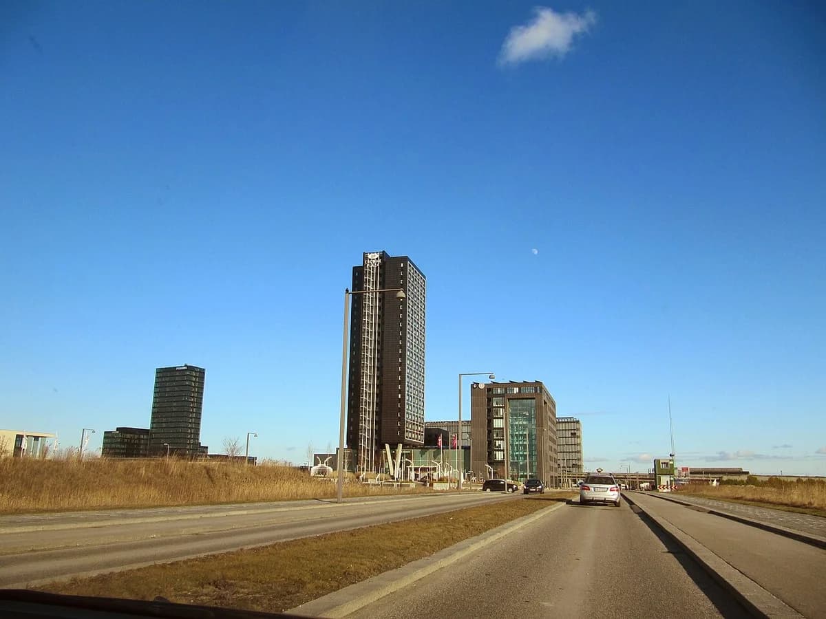 Modern high-rise buildings along a road in Copenhagen.