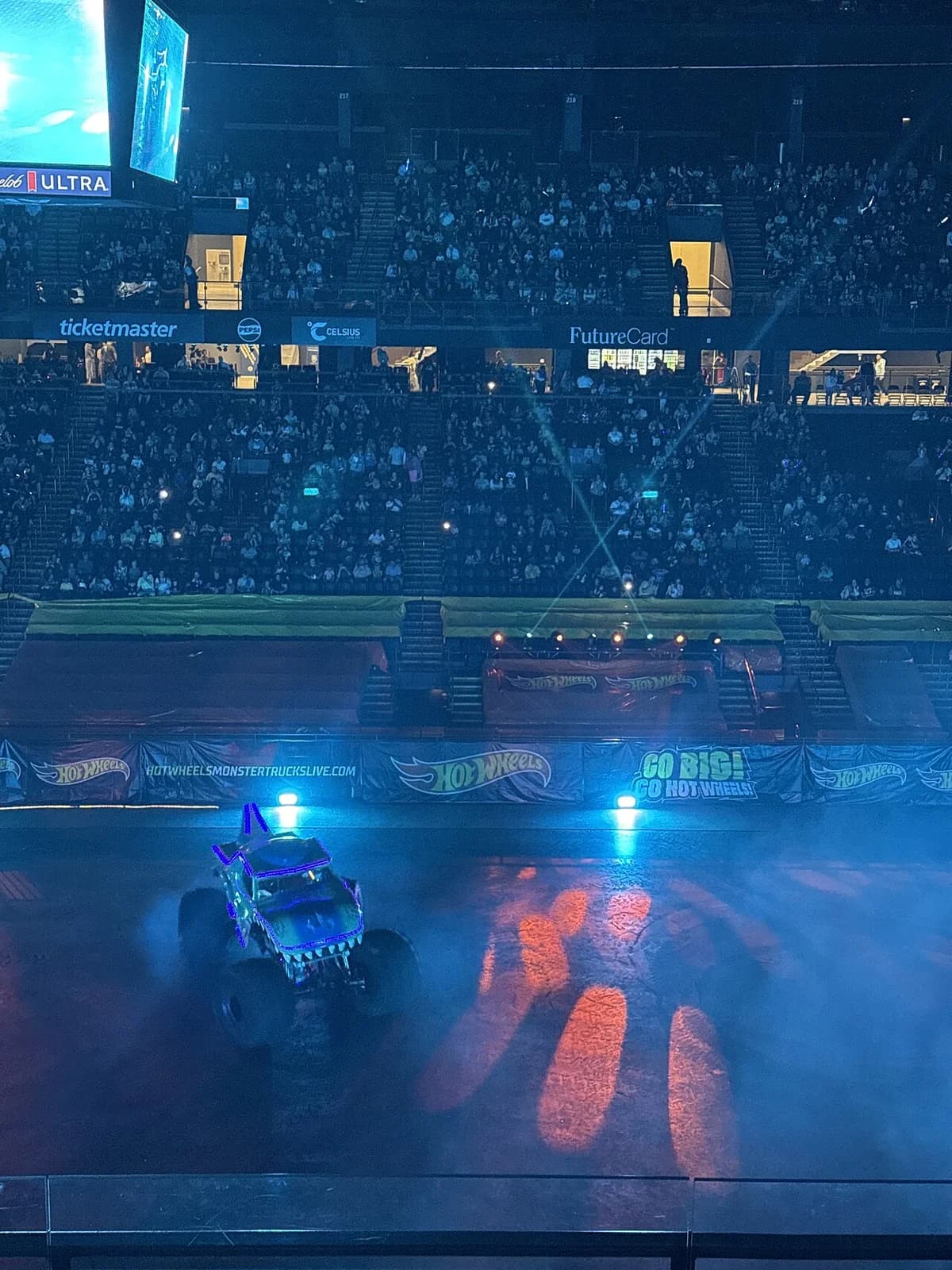 Hot Wheels themed monster truck in arena with audience