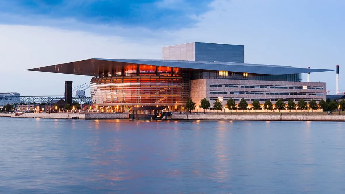 Royal Danish Opera House by the water at dusk