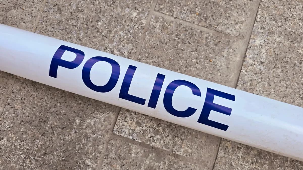Police barrier tape on stone pavement