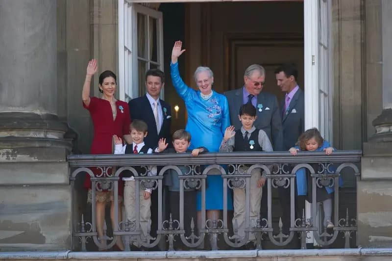 Danish royal family standing on balcony waving