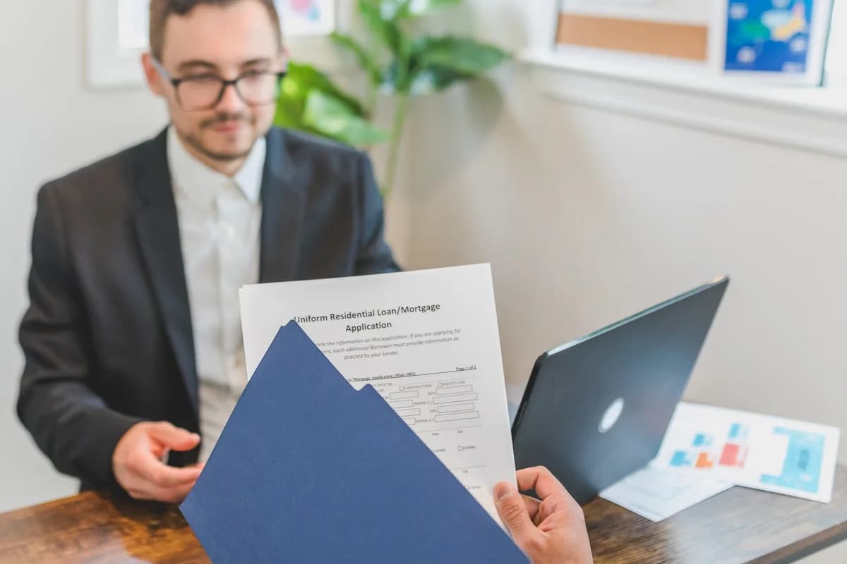 Mortgage broker and client discussing loan documents