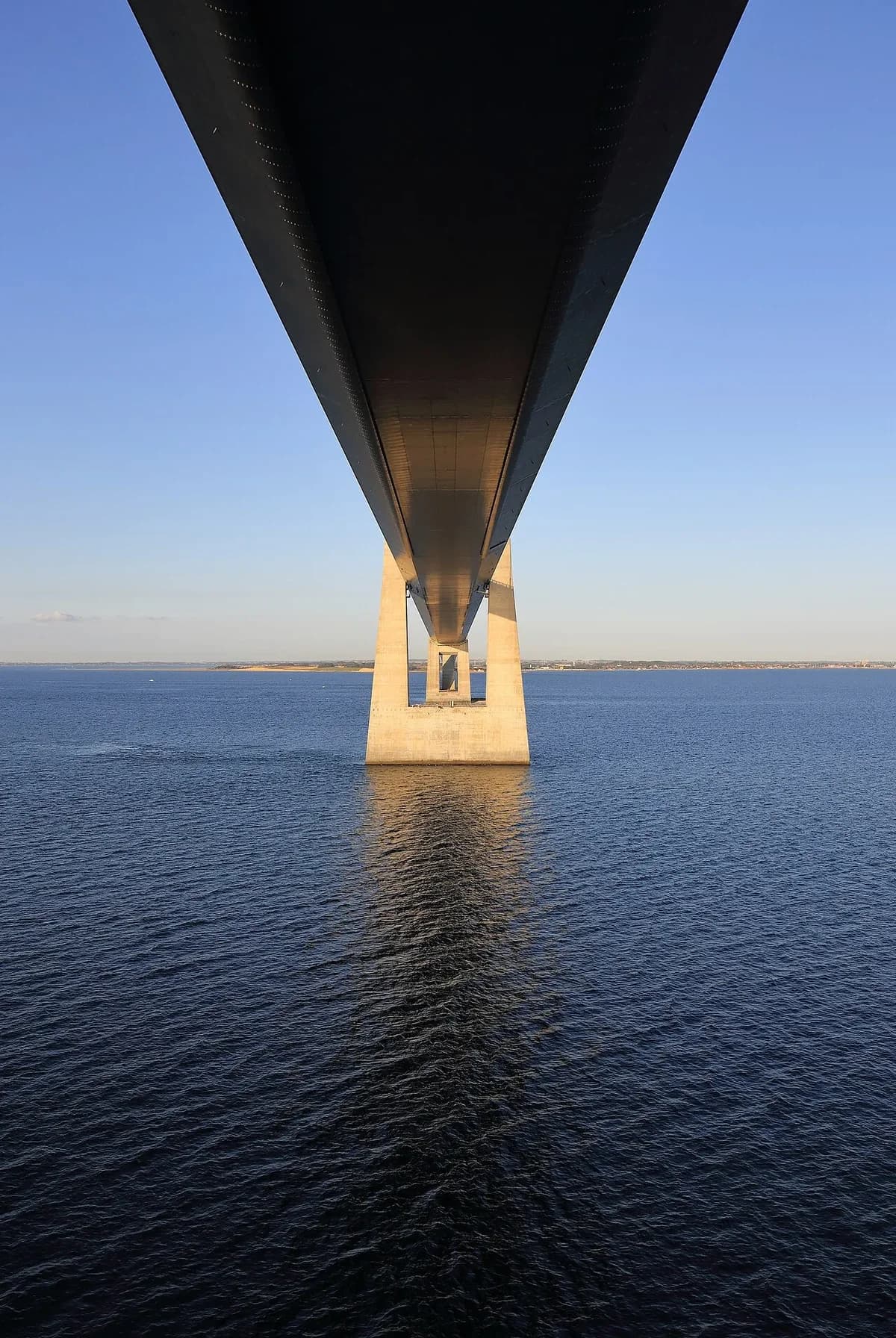 view beneath a large bridge over water