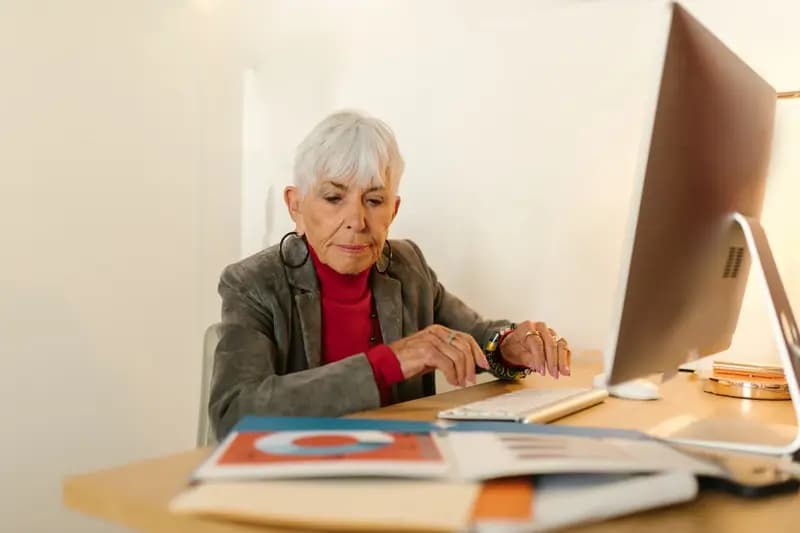 Older woman working at office desk