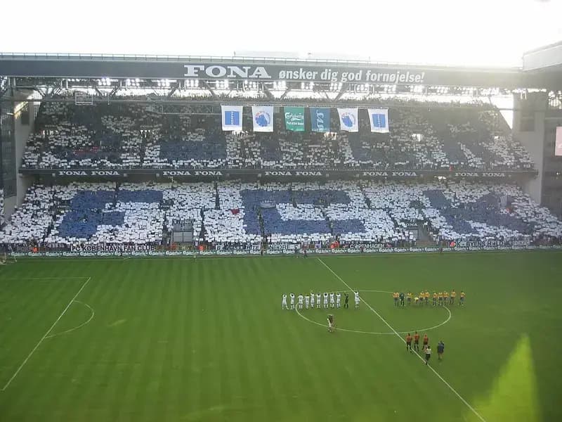 FC Copenhagen fans displaying blue and white tifo forming 'FCK' at Parken Stadium