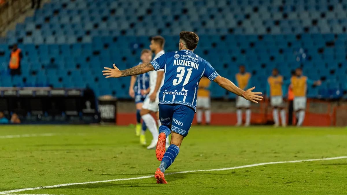Football player celebrating on field with arms outstretched