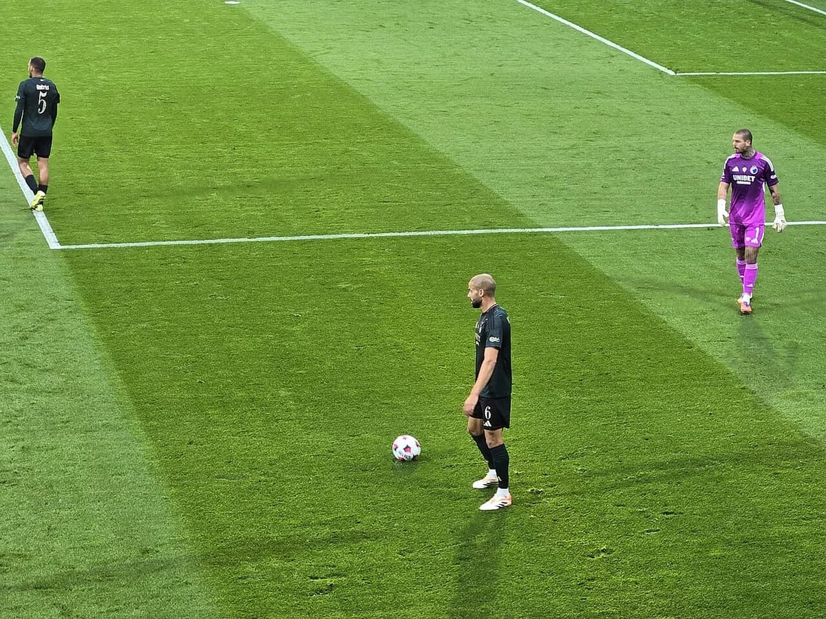 football players and goalkeeper on field