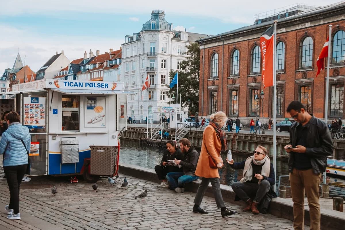 People enjoying street food next to a canal in Copenhagen
