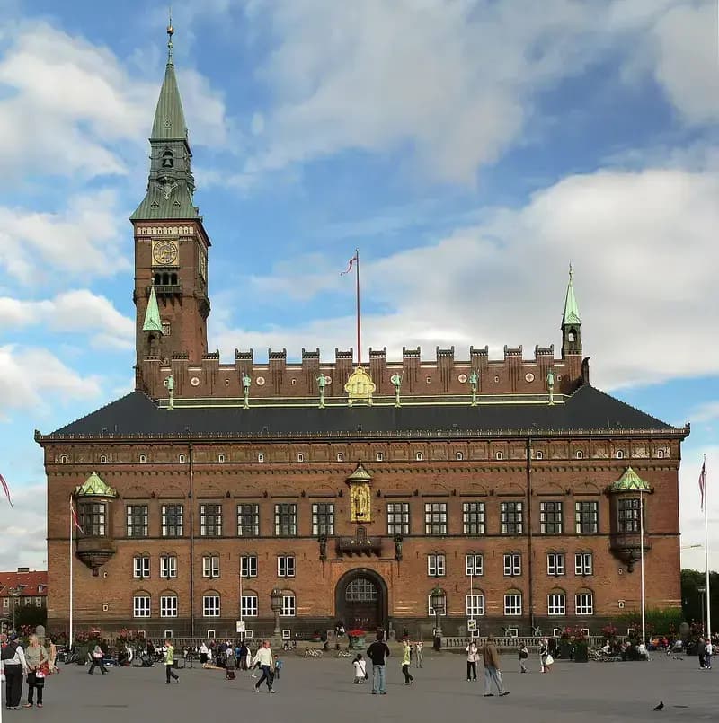 Copenhagen City Hall with clock tower and people in front